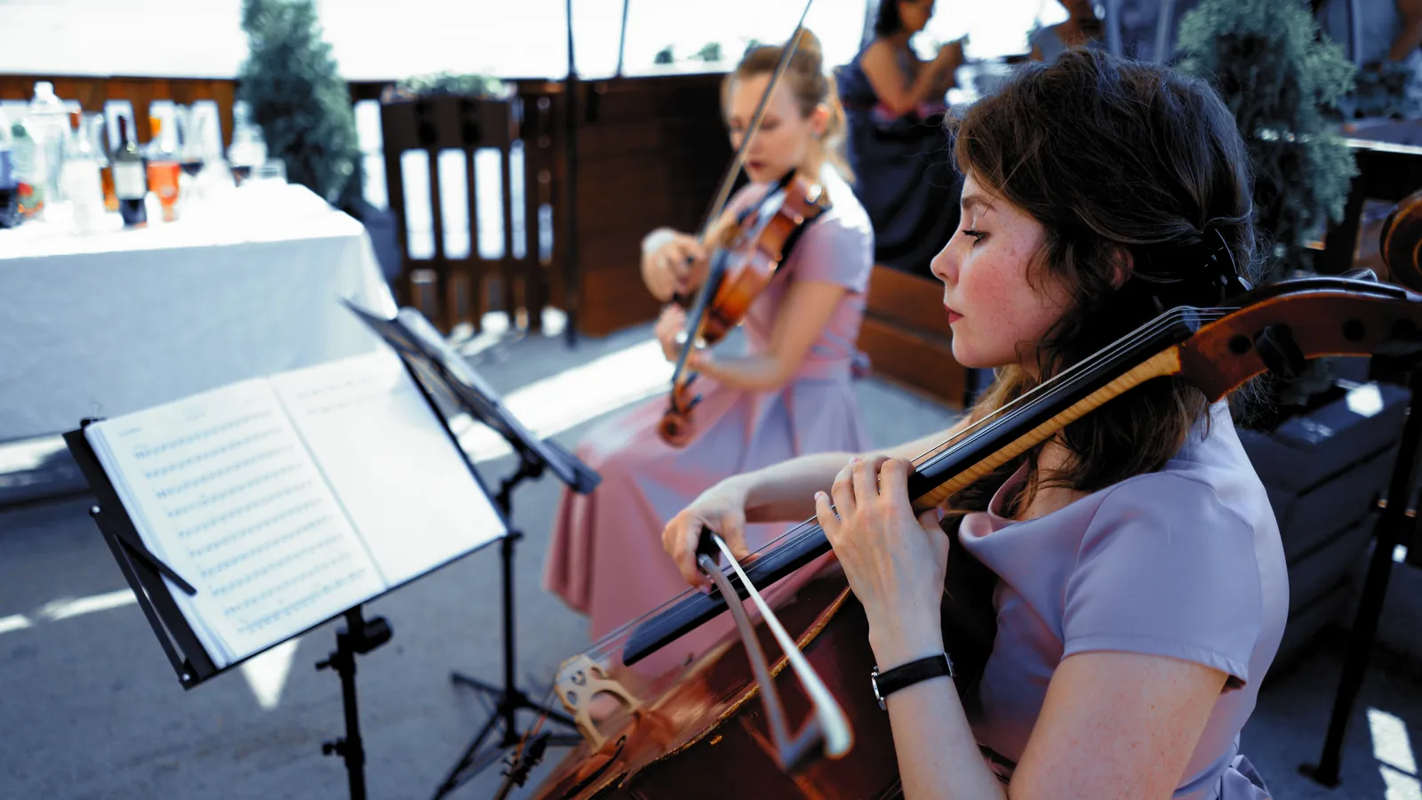 Classical Event: a cellist and violinist playing at an outdoor event