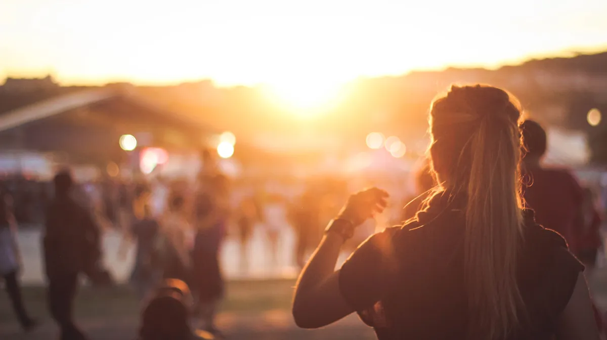 Girl watching the sunset at an outdoor event
