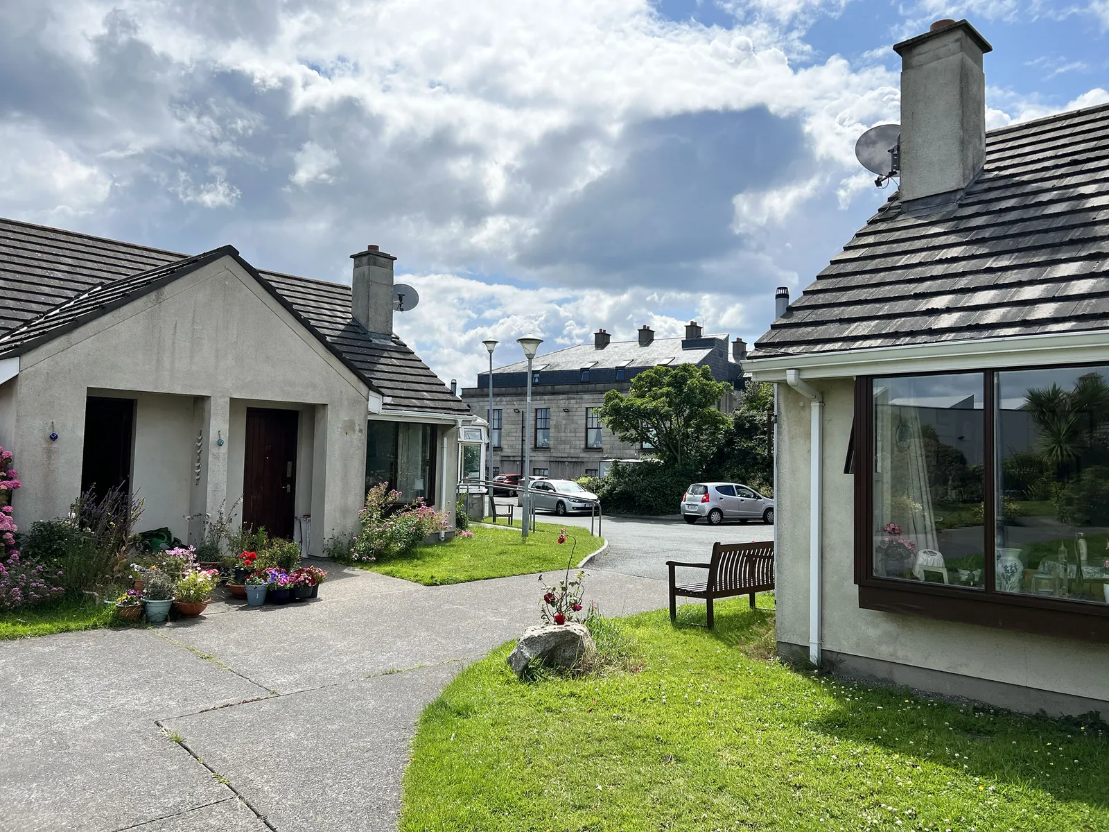 Bungalows with flower beds and a courtyard at Sue Ryder Dalkey