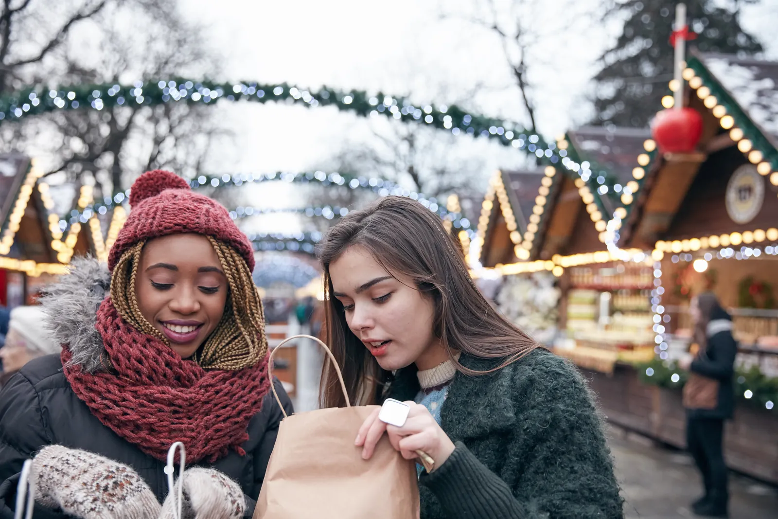 Two women shopping at a Christmas market